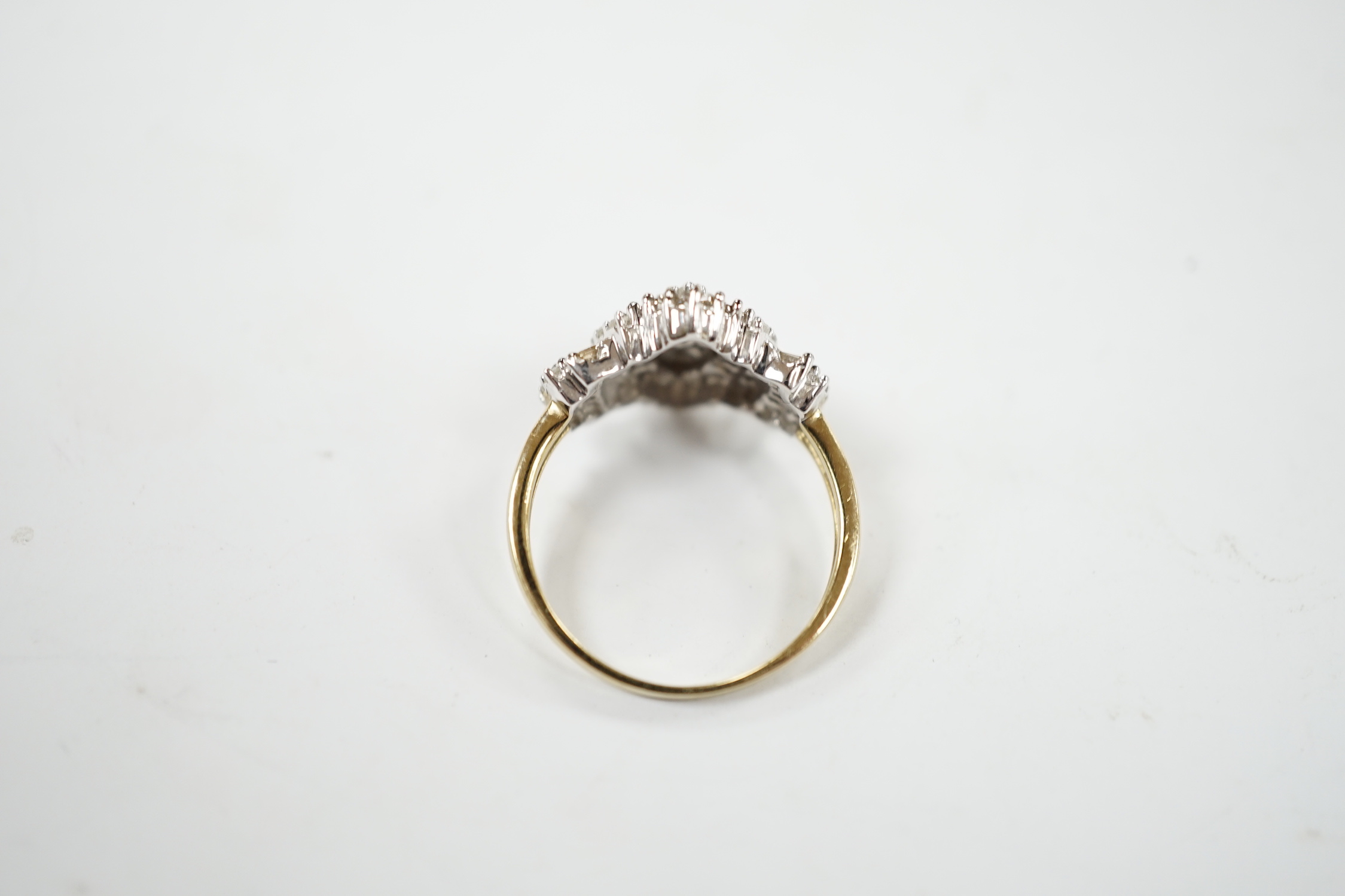A modern 9ct gold and diamond navette shaped cluster dress ring, set with baguette and round cut stones and diamond cluster set shoulders, size O/P, gross weight 3.2 grams.